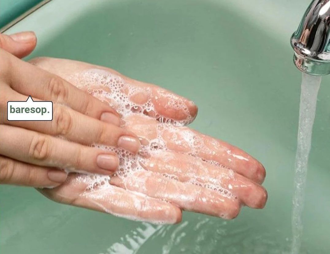 A photo of a person washing their hands