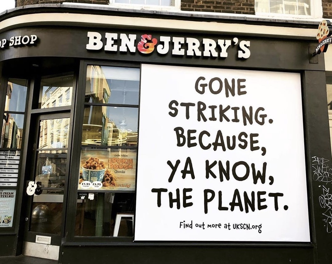 A photo of a Ben & Jerry's storefront featuring a climate strike message.